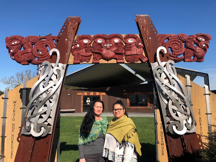 Hare Puke Scholarship winners Priscilla Davis Ngati and Tania Oxenham stand outside Te Kōpū Mānia o Kirikiriroa Marae