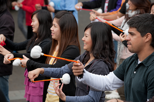 International students learning poi