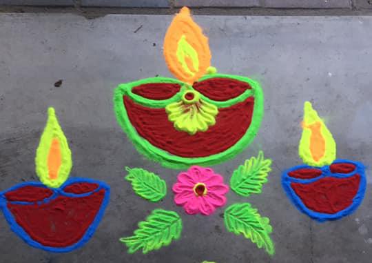 Colourful rangoli patterns in the shape of flowers and lamps.