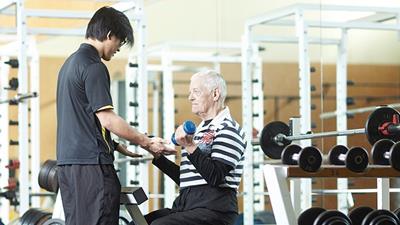 Waikato Human Performance Hub student assisting older man with exercise technique