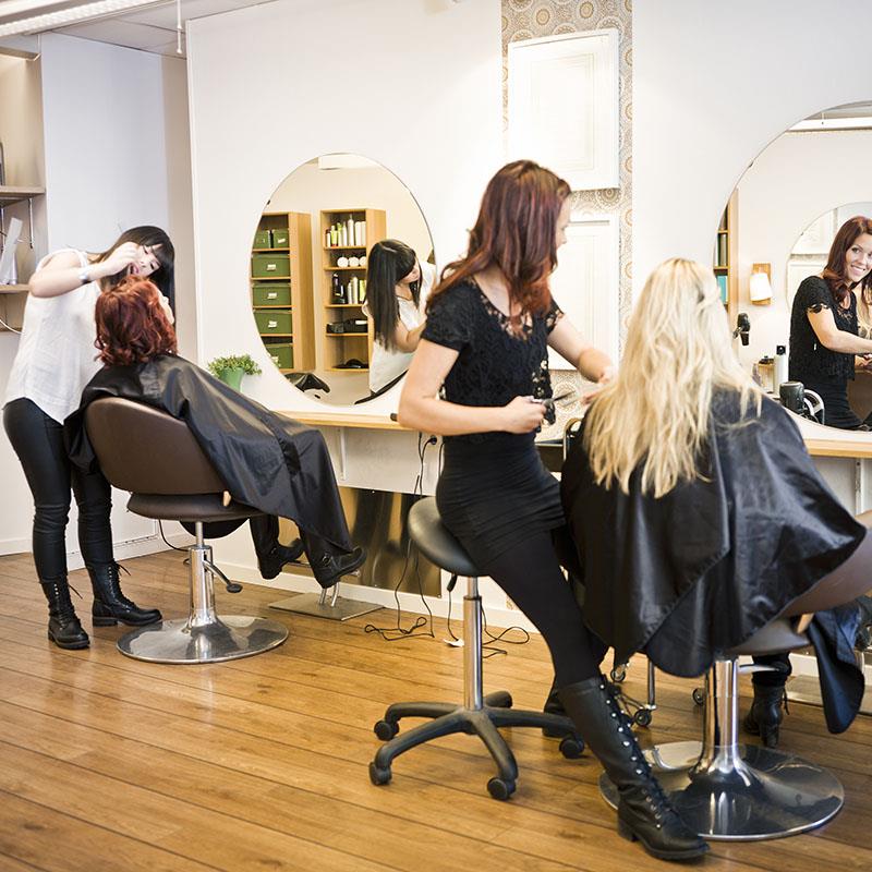 Clients getting their hair cut in a salon