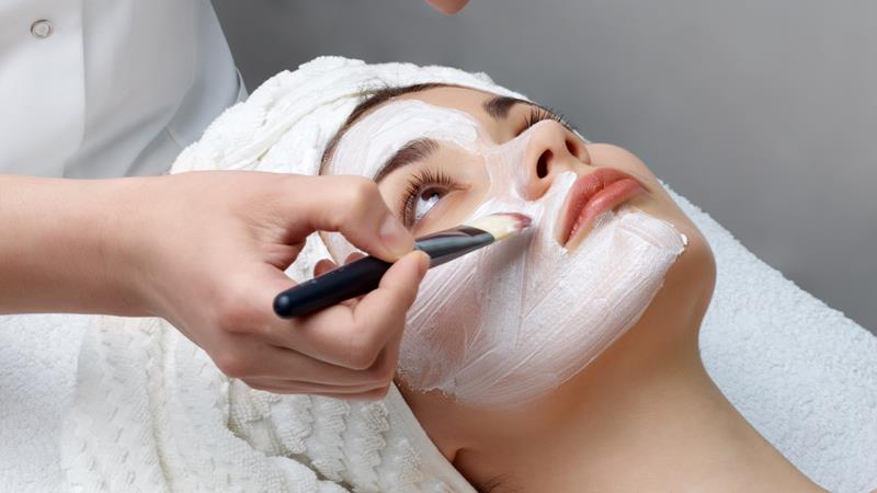 Woman receiving facial beauty therapy