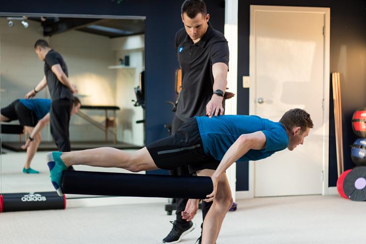 Luke Taylor demonstrating exercise technique with client