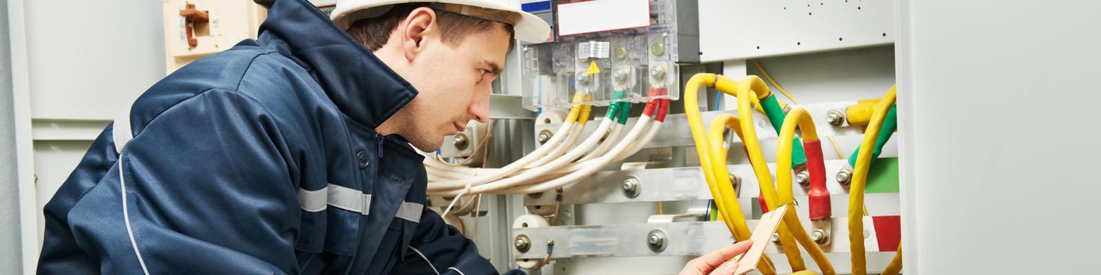 Electrical engineer examining wires