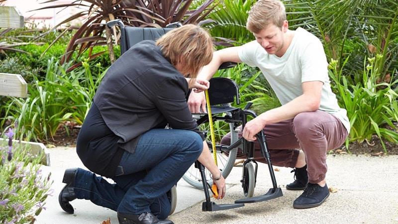 Occupational therapists measuring wheelchair