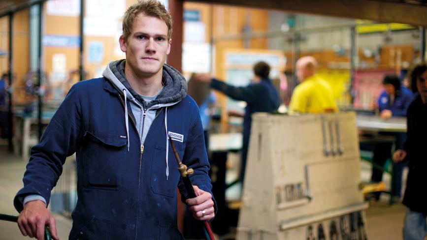 Trades student standing in workshop